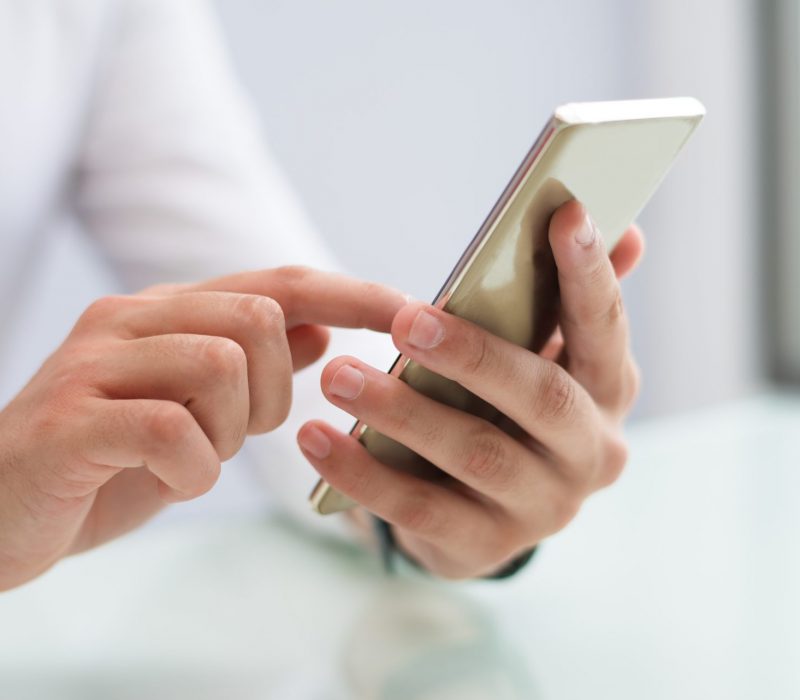 close-up-of-male-hands-using-smartphone